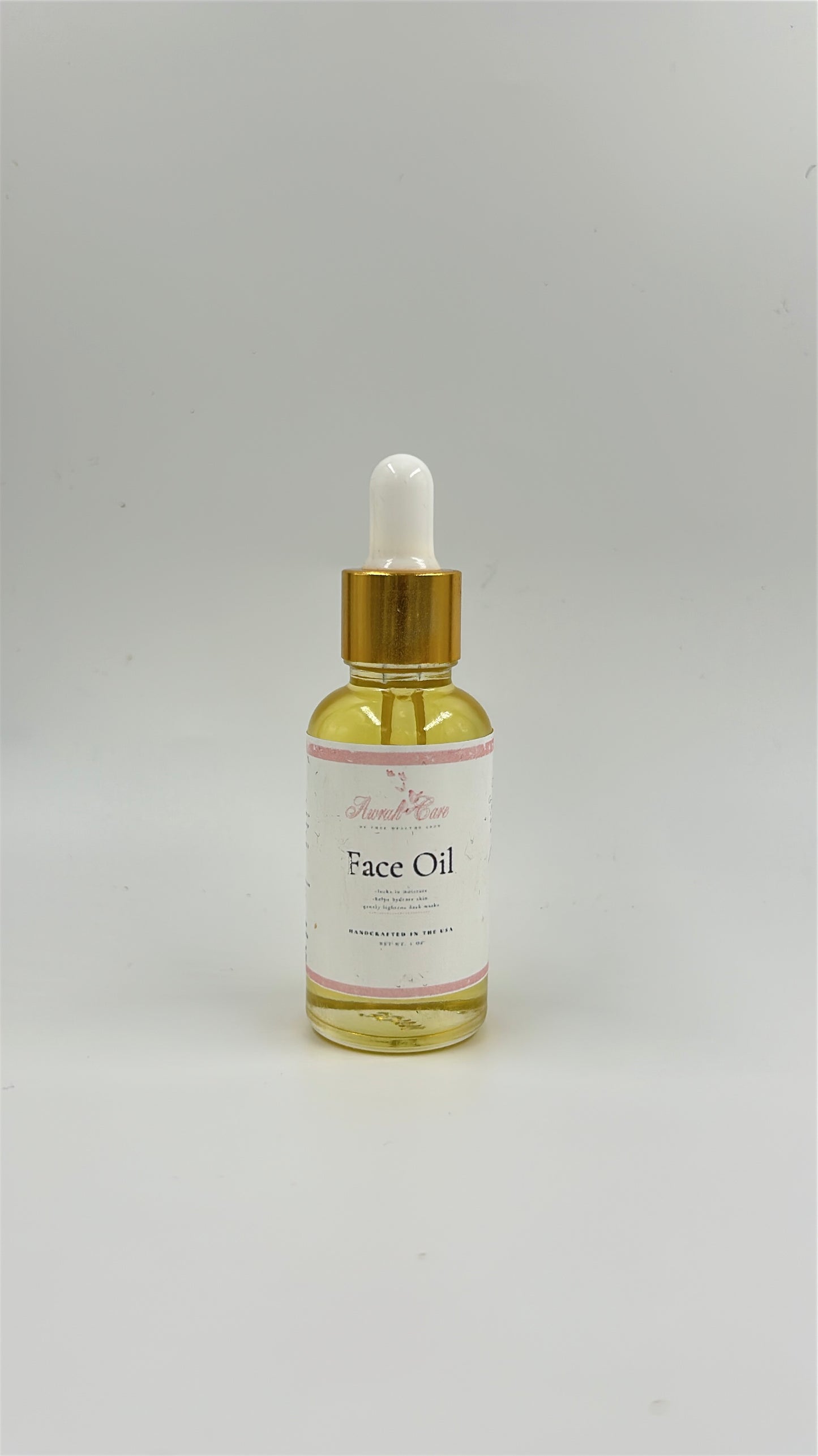 Bottle of face oil with dropper on a white background